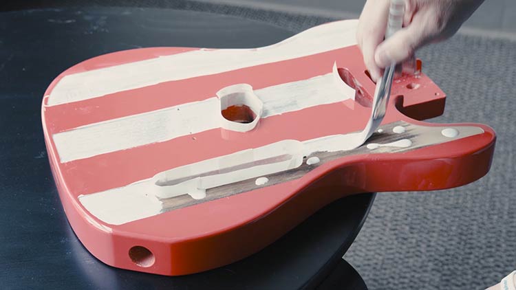 add white acrylic paint to finish the guitar