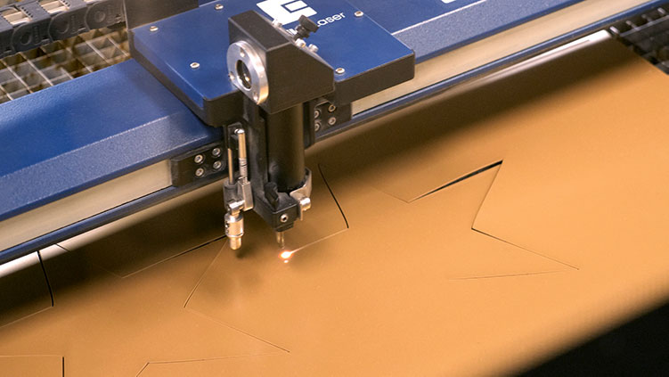 Laser cutting thin plastic into gold stars