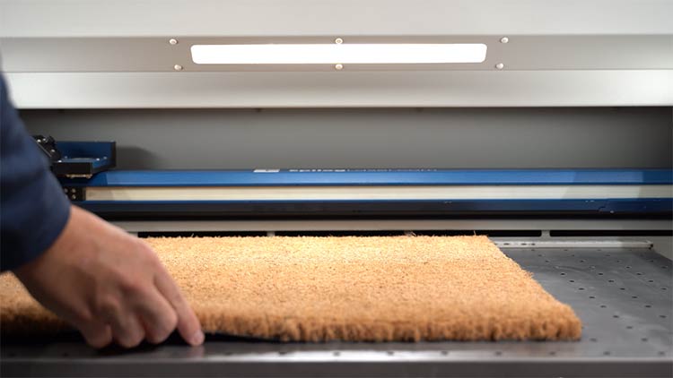 placing the coir doormat into the fusion pro laser