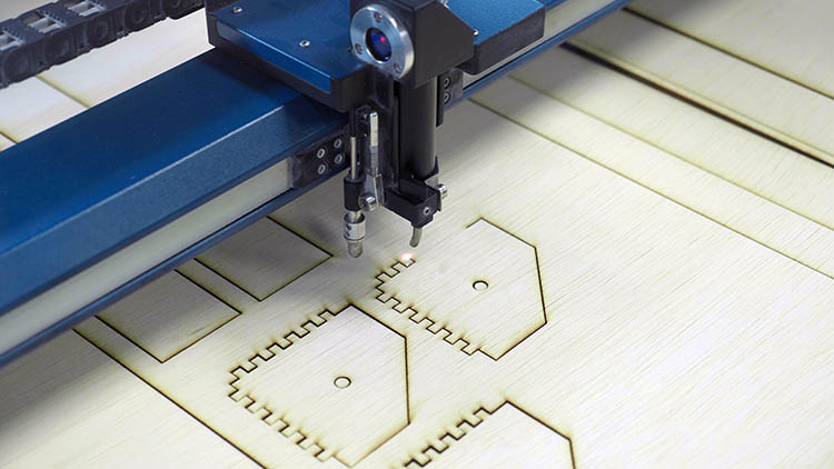 Epilog Laser machine cutting out finger joints.