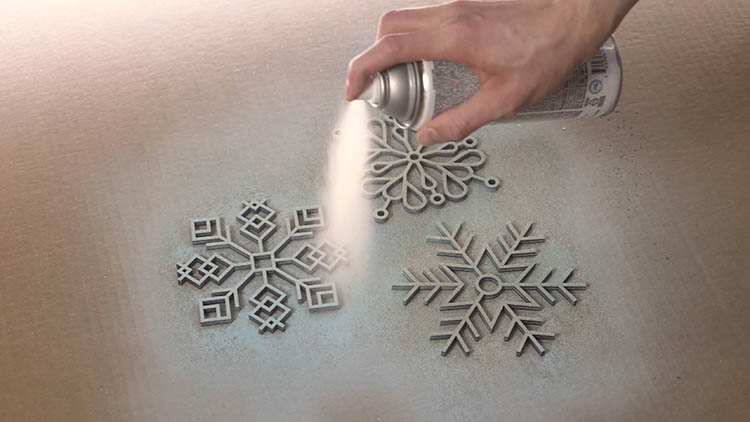 Spray painting laser cut snowflakes