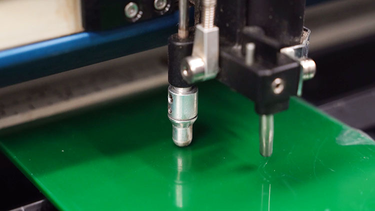 focusing the laser to the appropriate distance from material