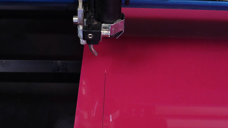cutting pink acrylic layer