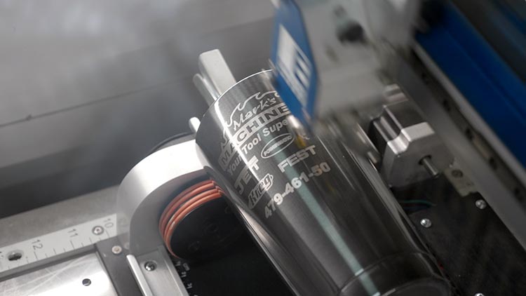 Laser engraving a dark grey tumbler with Mark's Machinery logo